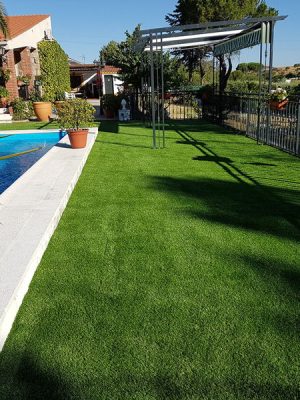 Instalación profesional de césped artificial en jardín residencial